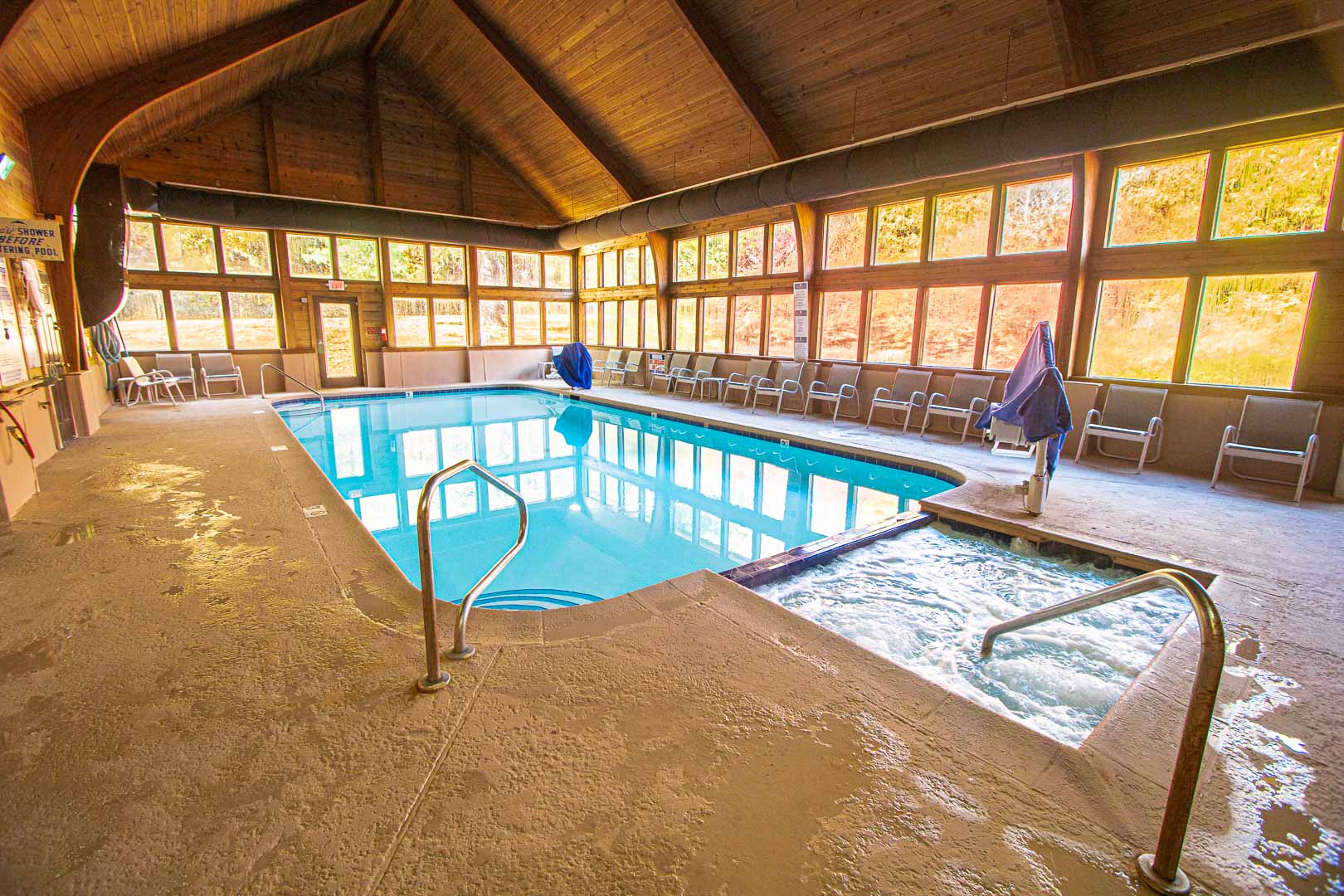A spacious indoor swimming pool and Jacuzzi at VRI's Mountain Loft Resort in North Carolina.